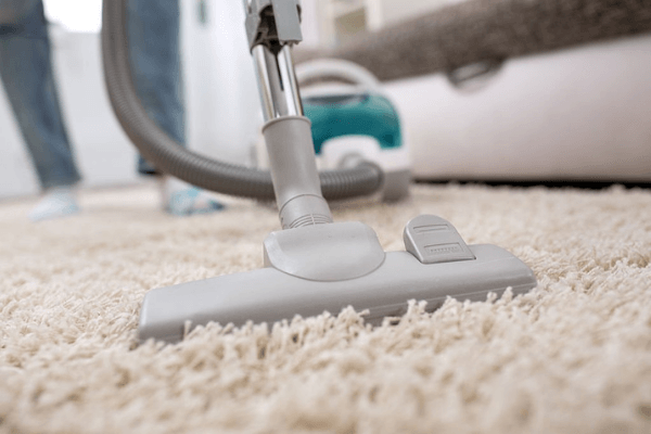 Vacuuming the carpet
